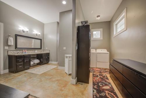 a large bathroom with a sink and a mirror at Hill Country Escape Hot Tub Pet Friendly in Dripping Springs