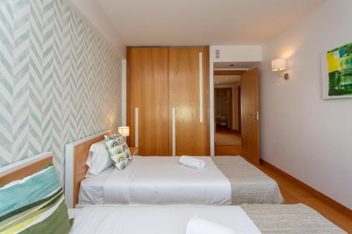 Ένα ή περισσότερα κρεβάτια σε δωμάτιο στο BeGuest Premium Lisbon Suites