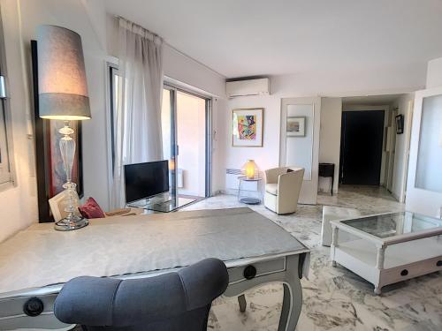 un grand salon avec un canapé et une table dans l'établissement A 2 pas des plages du Midi, terrasse, 252L-BOU, à Cannes