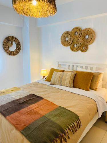 a bedroom with a large bed with two mirrors on the wall at NEW 2BD Aprt with Shared Rooftop Pool B3 in Athens