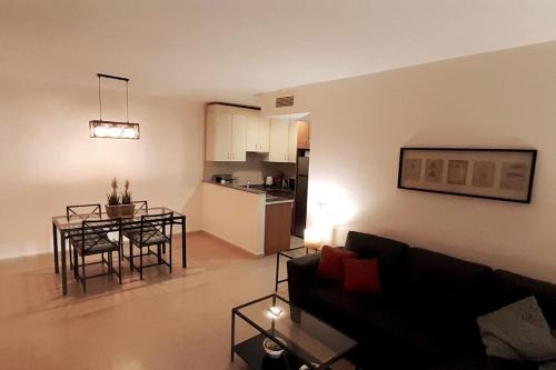 a living room with a couch and a table and a kitchen at La Terraza in Águilas