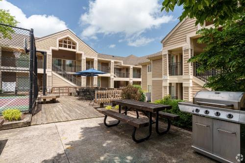 a backyard with a picnic table and a grill at Avia Residences on Lincoln - Extended Stay in Malvern