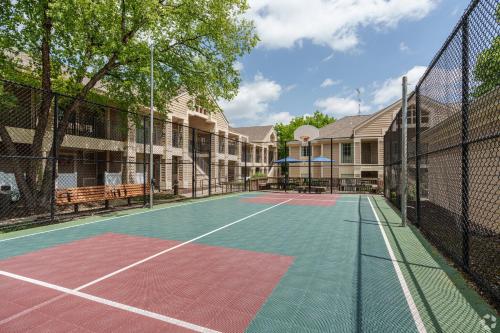 a tennis court in front of a house at Avia Residences on Lincoln - Extended Stay in Malvern