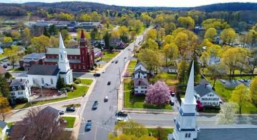 an aerial view of a small town with a church at Avia Residences on Research - Extended Stay in Westborough