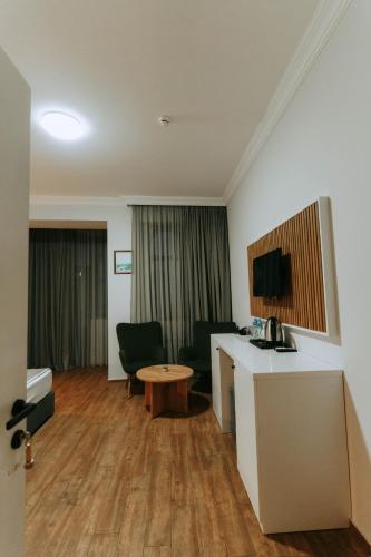 a room with a desk and chairs and a table at Hotel Old Town in Batumi