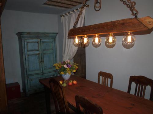 a dining room with a wooden table with lights on it at Natur erleben und Ruhe genießen in Neuentempel