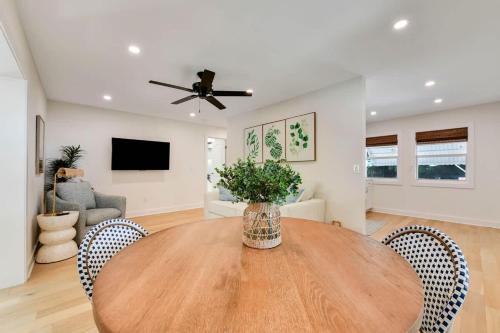 a dining room with a wooden table and chairs at Updated Cottage on Pine Ave in Stuart