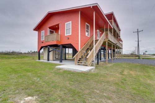 a large red house with stairs on the side of it at Balcony and Sunset Views Coastal Port Bolivar Gem in Port Bolivar