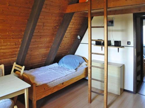 a bunk bed with a ladder in a room at Ferienhaus, Burhave in Burhave
