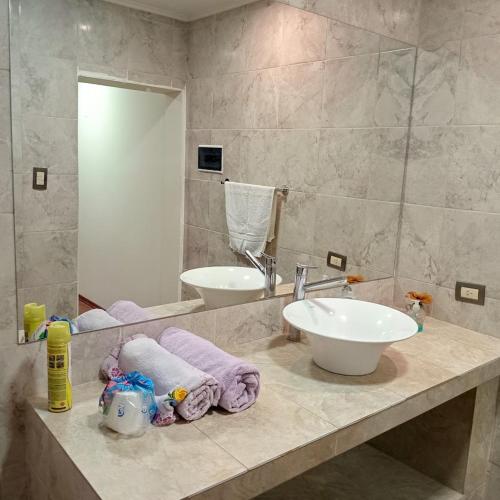 a bathroom with a sink and a mirror at Cabaña CALLE VIEJA in La Porteña