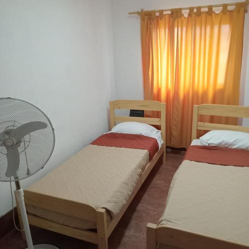 a room with two bunk beds and a fan at Cabaña CALLE VIEJA in La Porteña