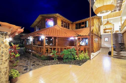 a wooden building with a bar in front of it at La Posada de Mindo in Mindo