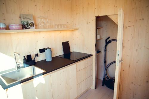 a kitchen with a counter top and a sink at Exklusive Cabins am Rursee inmitten der Natur – mlab relax Eifel in Simmerath