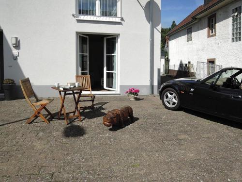 a black car parked in front of a house at Apartments, Lissendorf in Lissendorf