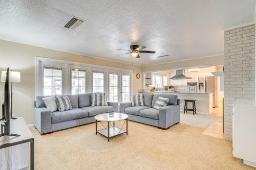 a living room with two couches and a table at 6 Mi to Legoland Retreat with Pool and Fenced Yard in Winter Haven