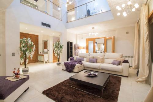 a living room with a couch and a table at Villa Mar in Almancil