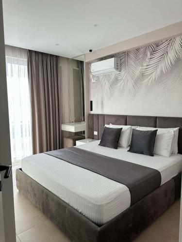 a bedroom with a large bed in a room at Sea View Apartment Luxury in Vlorë
