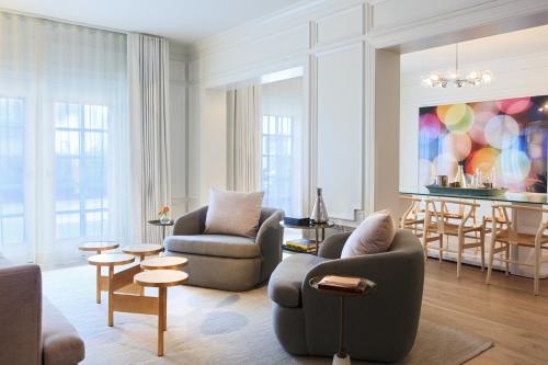 a living room with two chairs and a table at Kimpton Brice Hotel by IHG in Savannah