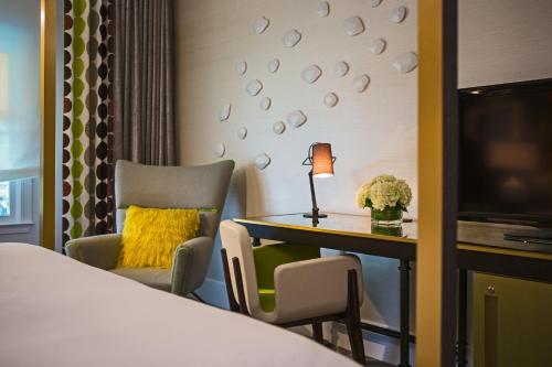a hotel room with a desk and a bed at Kimpton Brice Hotel by IHG in Savannah