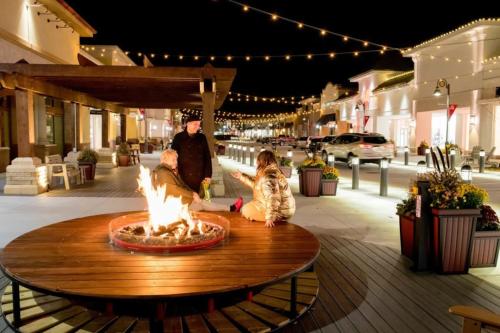a group of people sitting around a fire pit on a street at Quiet Convenient Pvt Room in shared home Perfect for Travelers in Plymouth