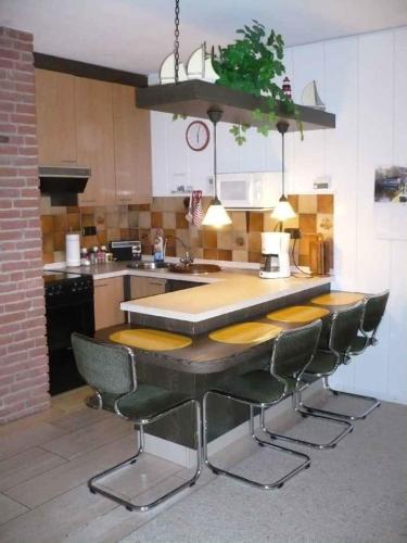 a kitchen with a table and chairs in it at Appartment 3737 in Tossens in Tossenserdeich