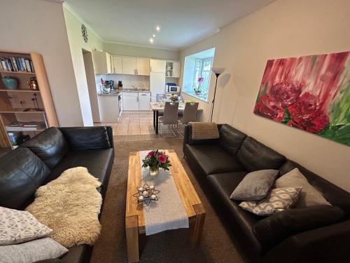 a living room with a couch and a table at Ferienwohnung Seeschwalbe in Hagermarsch