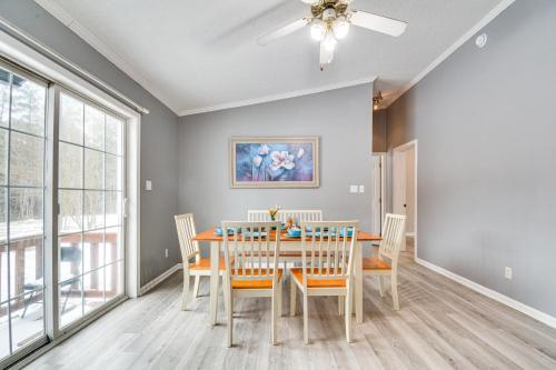 a dining room with a table and chairs and a ceiling fan at 8 Mi to Jordan Lake Spacious New Hill Home in Apex