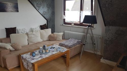 a living room with a couch and a table at Ferienwohnung Conny in Butjadingen