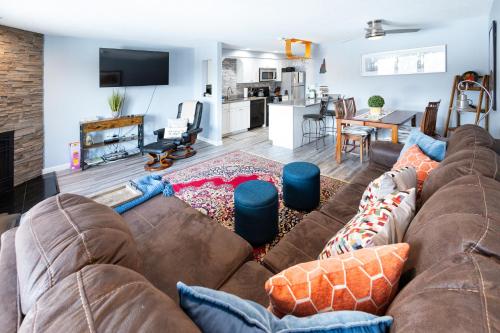 a living room with a brown couch and a kitchen at White Mountains Getaway with amazing views! in Bartlett