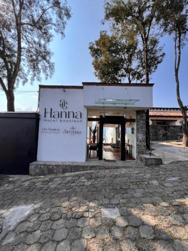 a building with a sign on the side of it at Hanna Hotel Boutique in Valle de Bravo