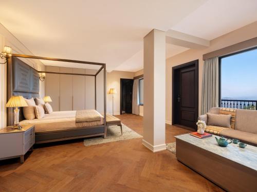 a bedroom with a large bed and a couch at Amaraya by LaRiSa, Nainital in Rāmgarh
