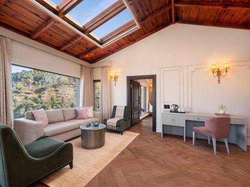 a living room with a couch and a table at Amaraya by LaRiSa, Nainital in Rāmgarh