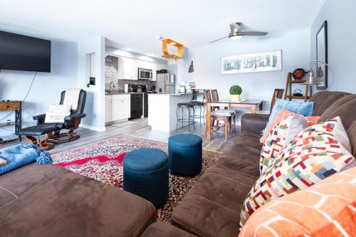 a living room with a couch and a kitchen at White Mountains Getaway with amazing views! in Bartlett