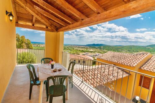 a patio with a table and chairs on a balcony at Residence in Malamurì near Budoni, apartments 4 beds with private outdoor area in Budoni