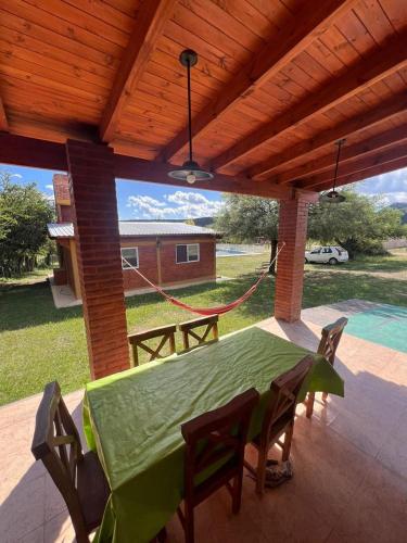 a patio with a table and chairs and a swing at Cabañas San Lorenzo in San Lorenzo