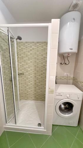 a bathroom with a washing machine and a washer at Rose Wind Apartments by Pag tours in Pag