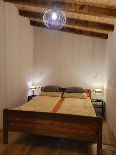 a bedroom with a bed in a room with two lamps at Apartments Kristic in Grabovac