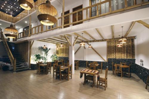 a restaurant with tables and chairs in a room at La Posada de Mindo in Mindo