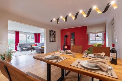 a dining room and living room with a table and chairs at Villa Agni in Dänschendorf