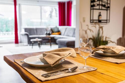 a table with a plate and wine glasses on it at Villa Agni in Dänschendorf