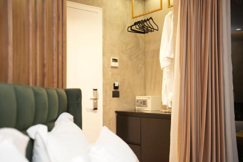 a hotel room with a bed and a microwave at La Suite Boutique Hotel in Tirana