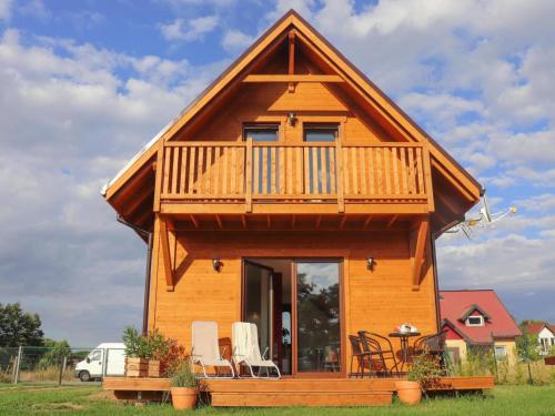 a log cabin with a balcony and a deck at holiday home in Stepnica for 6 persons in Stepnica