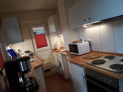 a kitchen with a coffee maker and a microwave at Haus Birkenheim in Kirchhatten