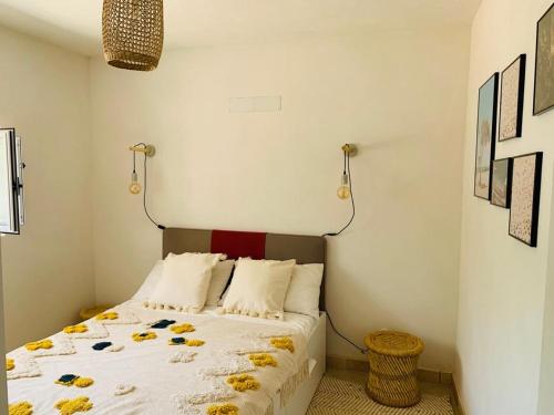 a bedroom with a bed with yellow flowers on it at Trullo Sasamaka Ostuni in Carovigno