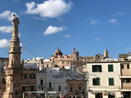 a city skyline with a statue in the foreground at Trullo Sasamaka Ostuni in Carovigno