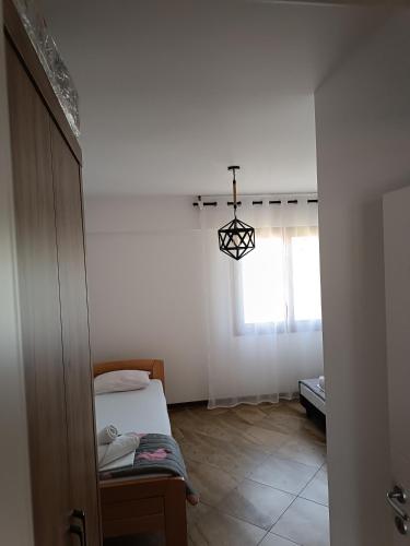 a small room with a bed and a window at Apartman Avala Beograd in Beli Potok