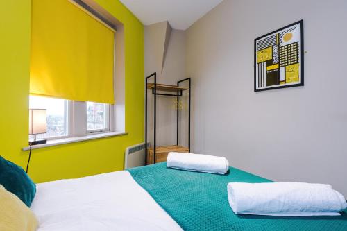 a bedroom with a bed with two pillows on it at Stylish 2 Bedroom Apartment in Central Wigan by MDGC Developments Ideal For Weekends Away and Business Guests in Wigan
