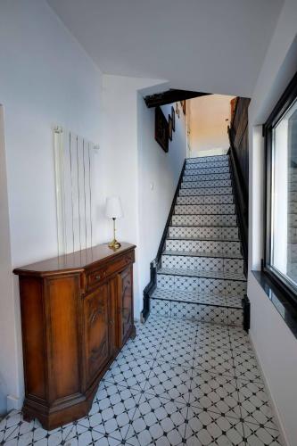 a hallway with a stairway with a table and a stair case at Florian's Haus in Cisnadioara