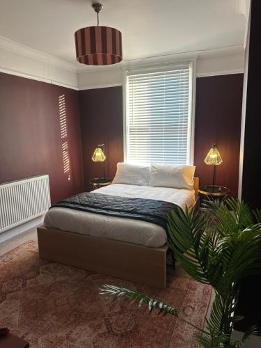 a bedroom with a bed and a plant in it at Charming city home free parking in Portsmouth