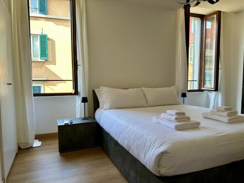 a bedroom with a bed with towels on it at Magic Place Bergamo! Beauty Nest Apartment in the heart of the city in Bergamo